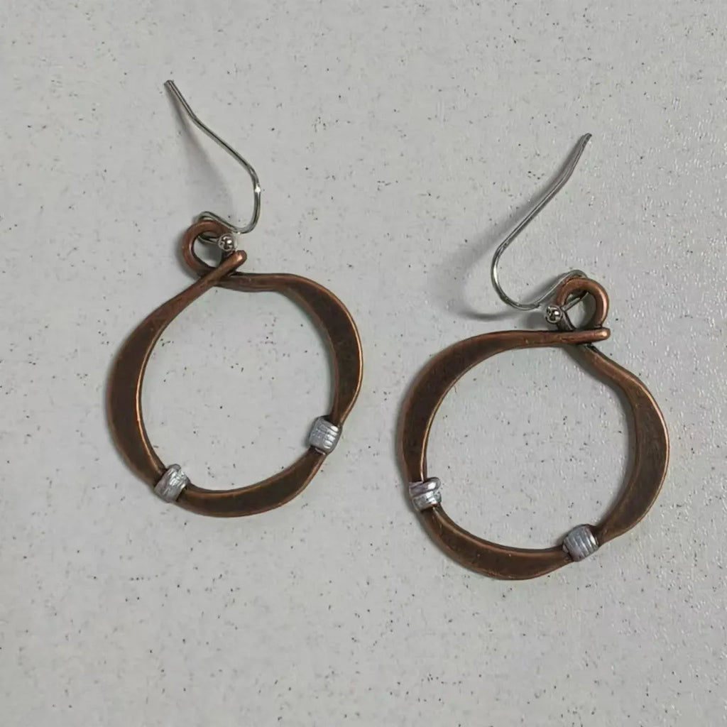 Retro hollow round bohemian earrings with bronze finish cable trim on female ear