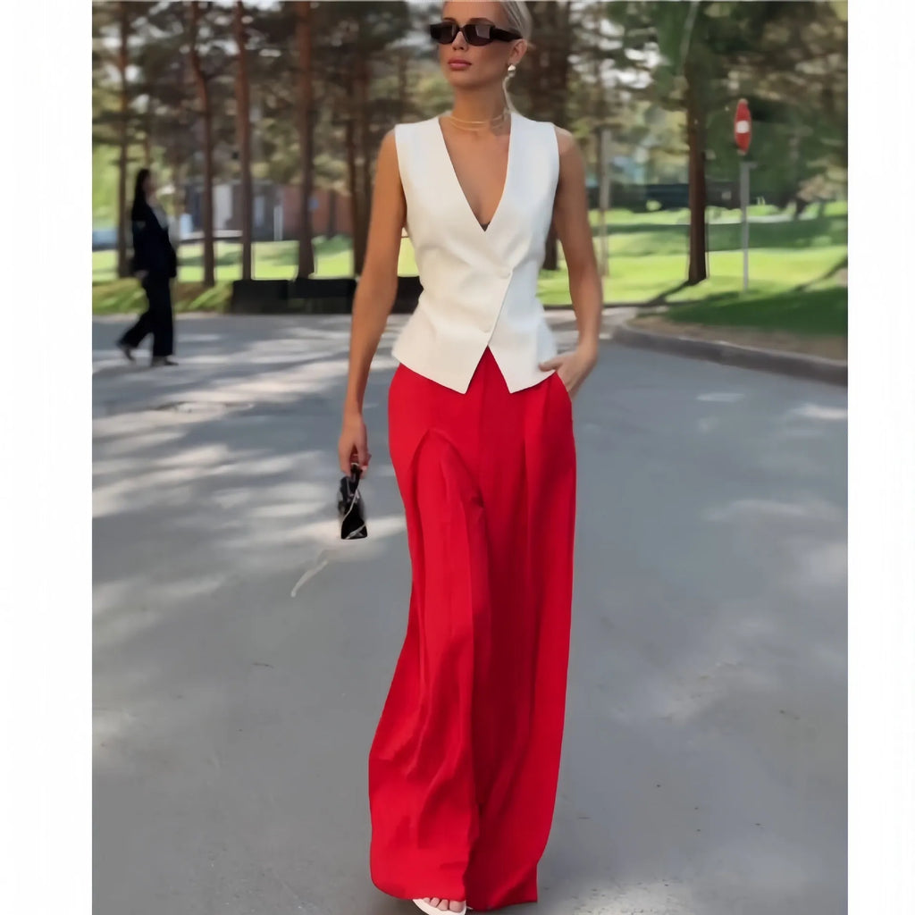 Beige women's two-piece set with sleeveless V-neck top and wide-leg trousers on a hanger.
