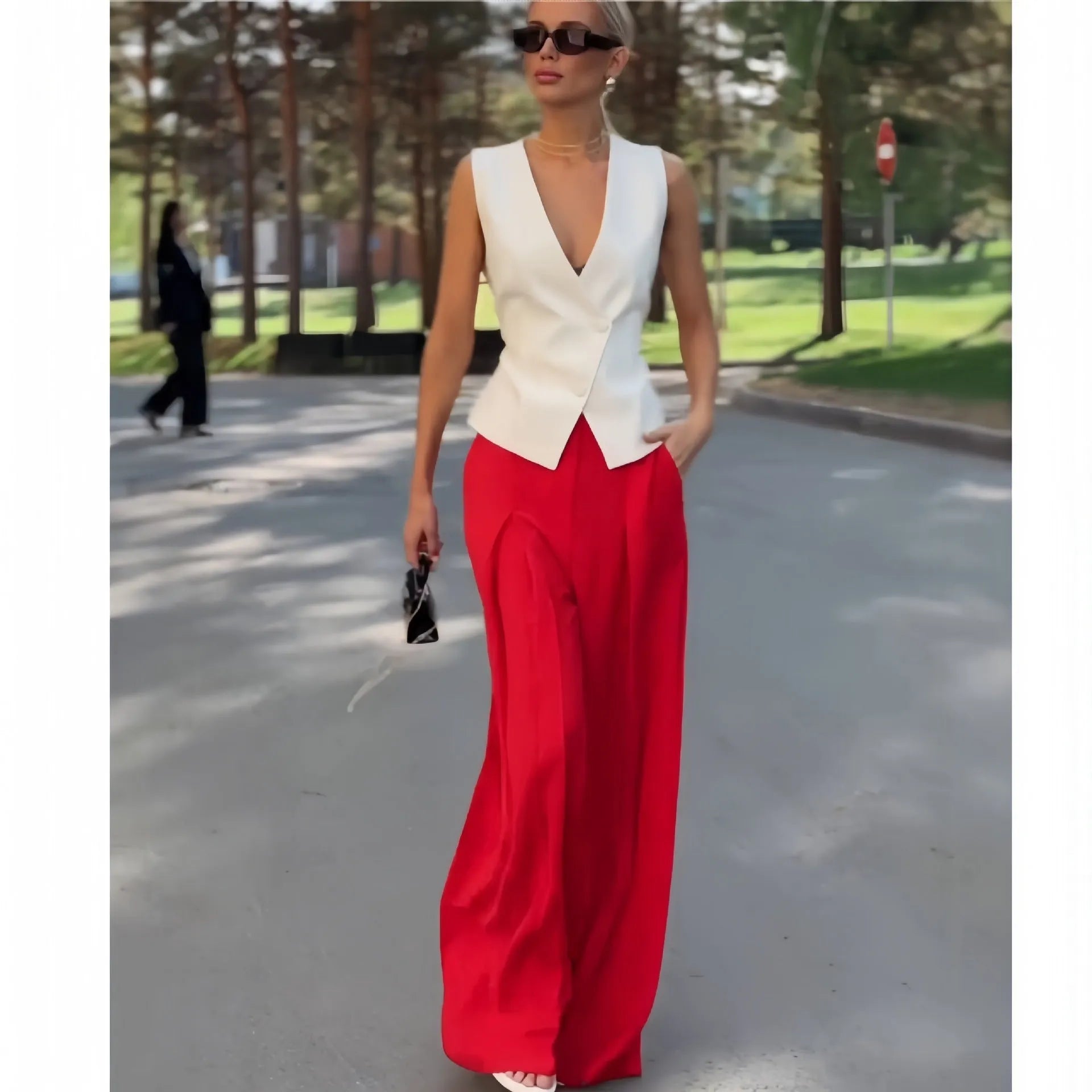 Beige women's two-piece set with sleeveless V-neck top and wide-leg trousers on a hanger.