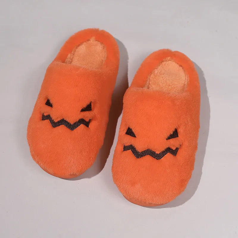 Orange Halloween pumpkin slippers with plush lining and a textured non-slip PVC sole.