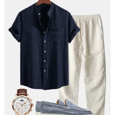 Men's blue slim-fit short-sleeved shirt with stand collar, part of a set with trousers, shoes, and watch