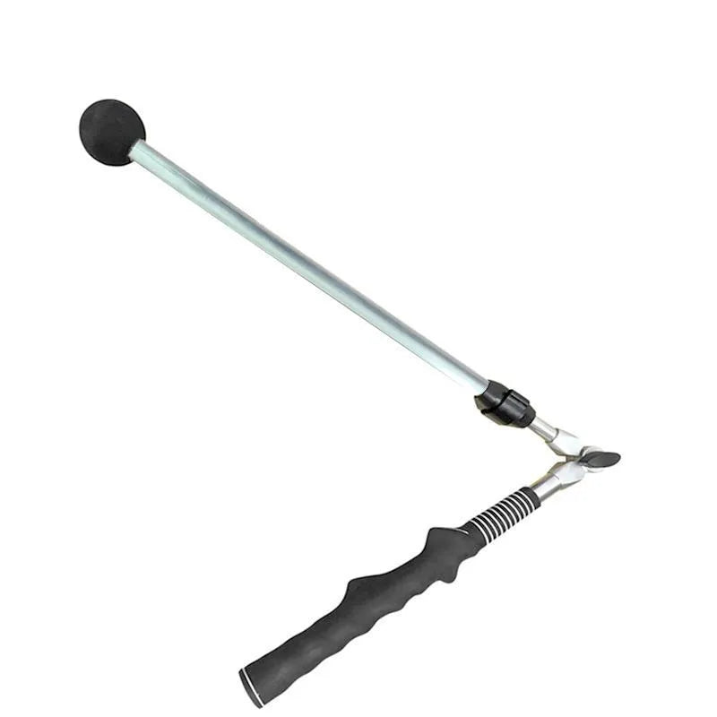 Golf folding swing trainer with black aluminium shaft and rubber grip on grass
