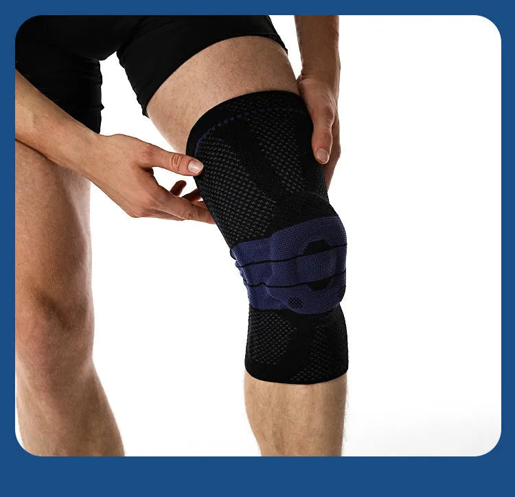 Adult sports knee pad in black and blue colour, shown on a knee for running and basketball protection.