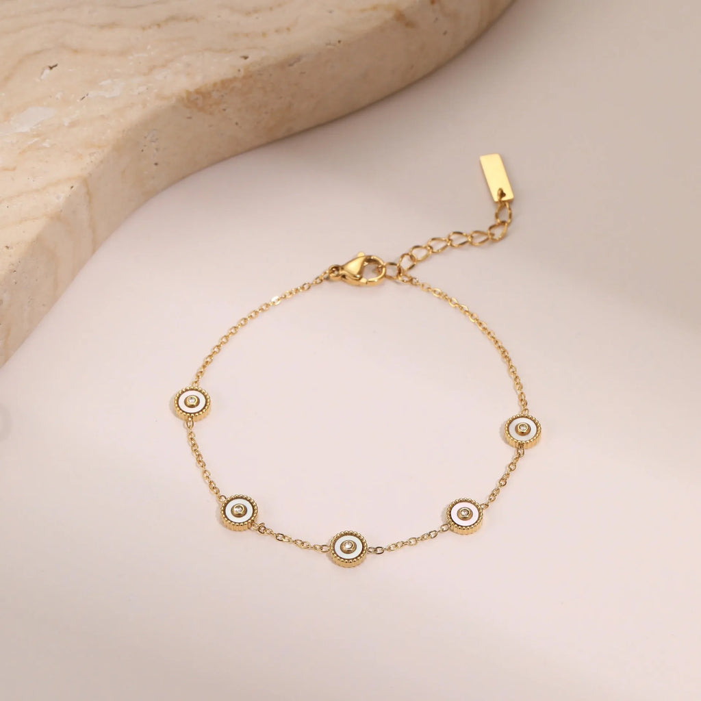 Geometric fritillary design bracelet and necklace set with 18K gold plating on stainless steel.