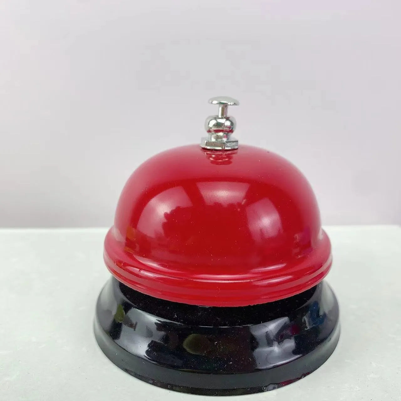 Iron game bell shown in one of ten available colours: blue, green, pink, red, yellow, green tea, or rose kiss.