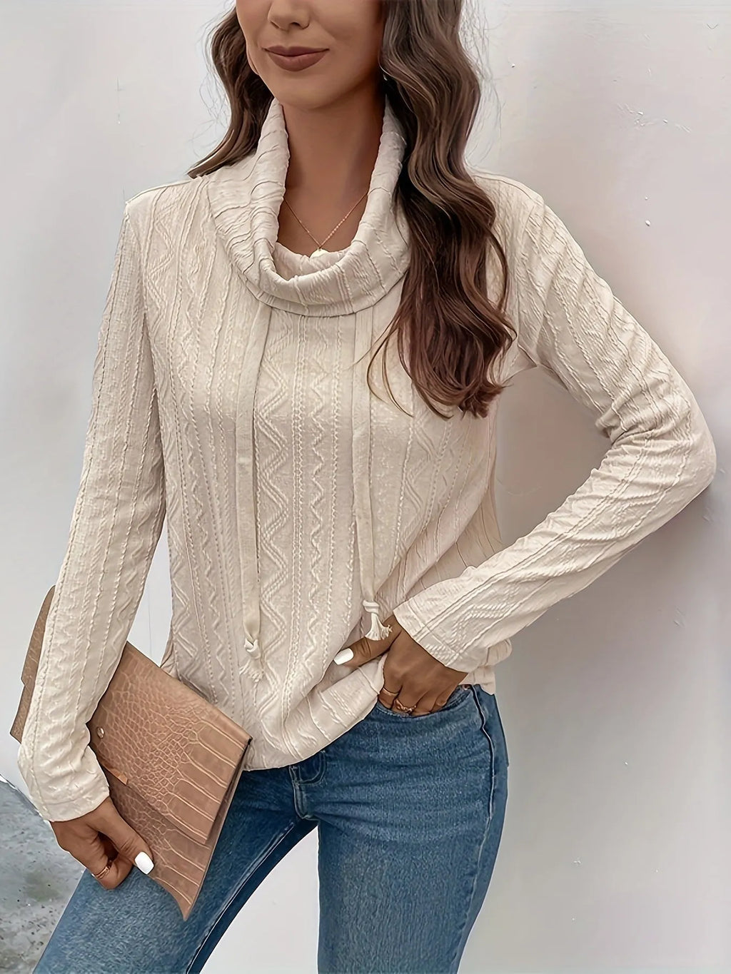 Apricot coloured long sleeve hooded pullover sweater on a hanger