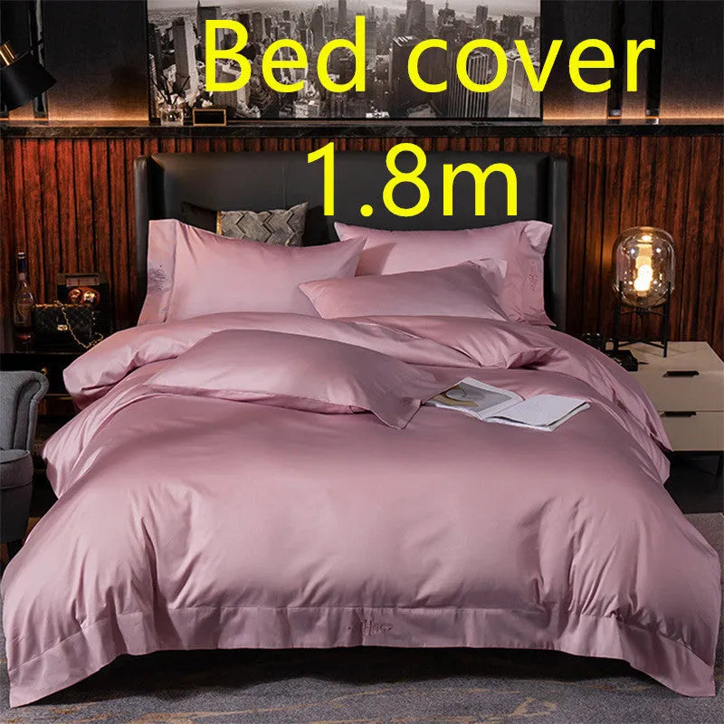 Four-piece cotton satin quilted bedding set with duvet cover, sheet, and pillowcases in a bedroom setting