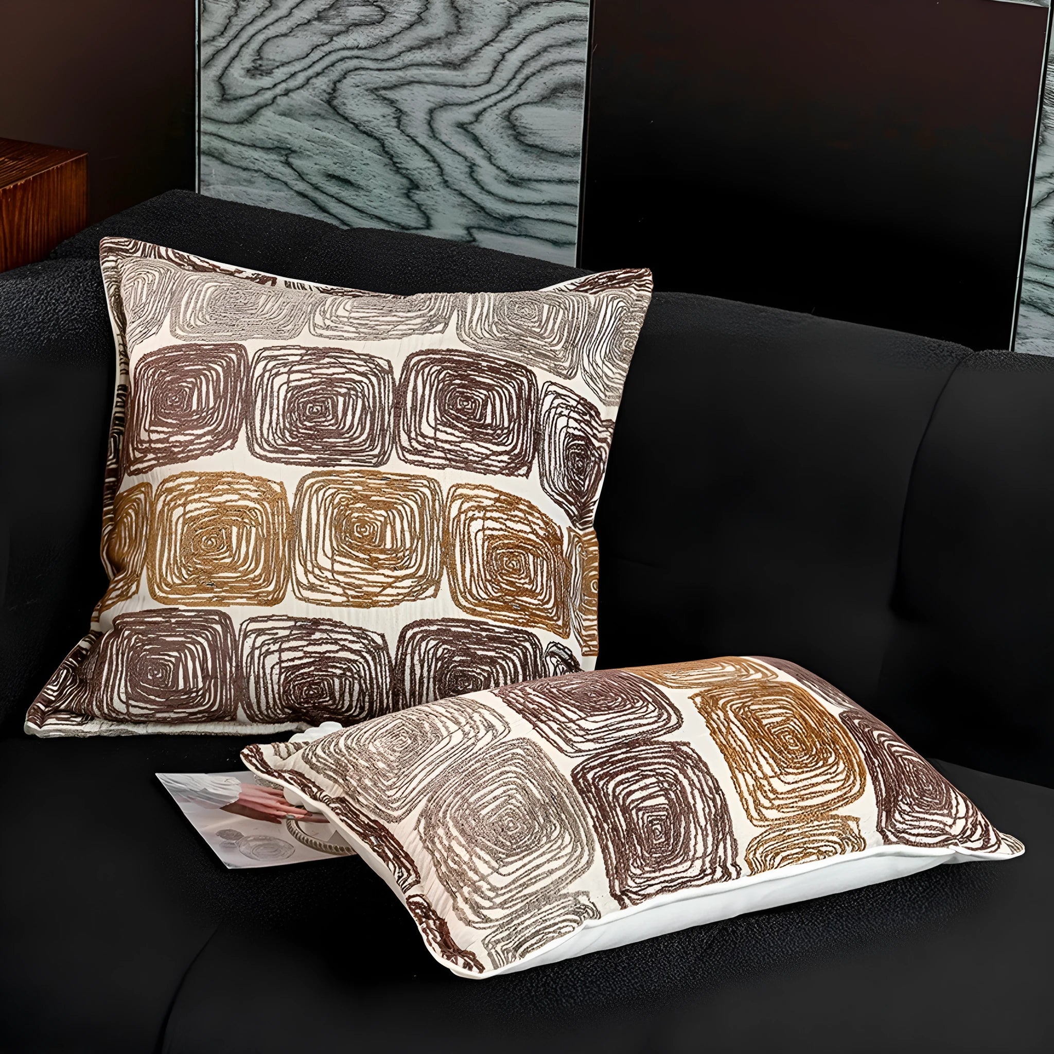 Abstract coil pattern cushion cover with piping trim in cream and coffee colours