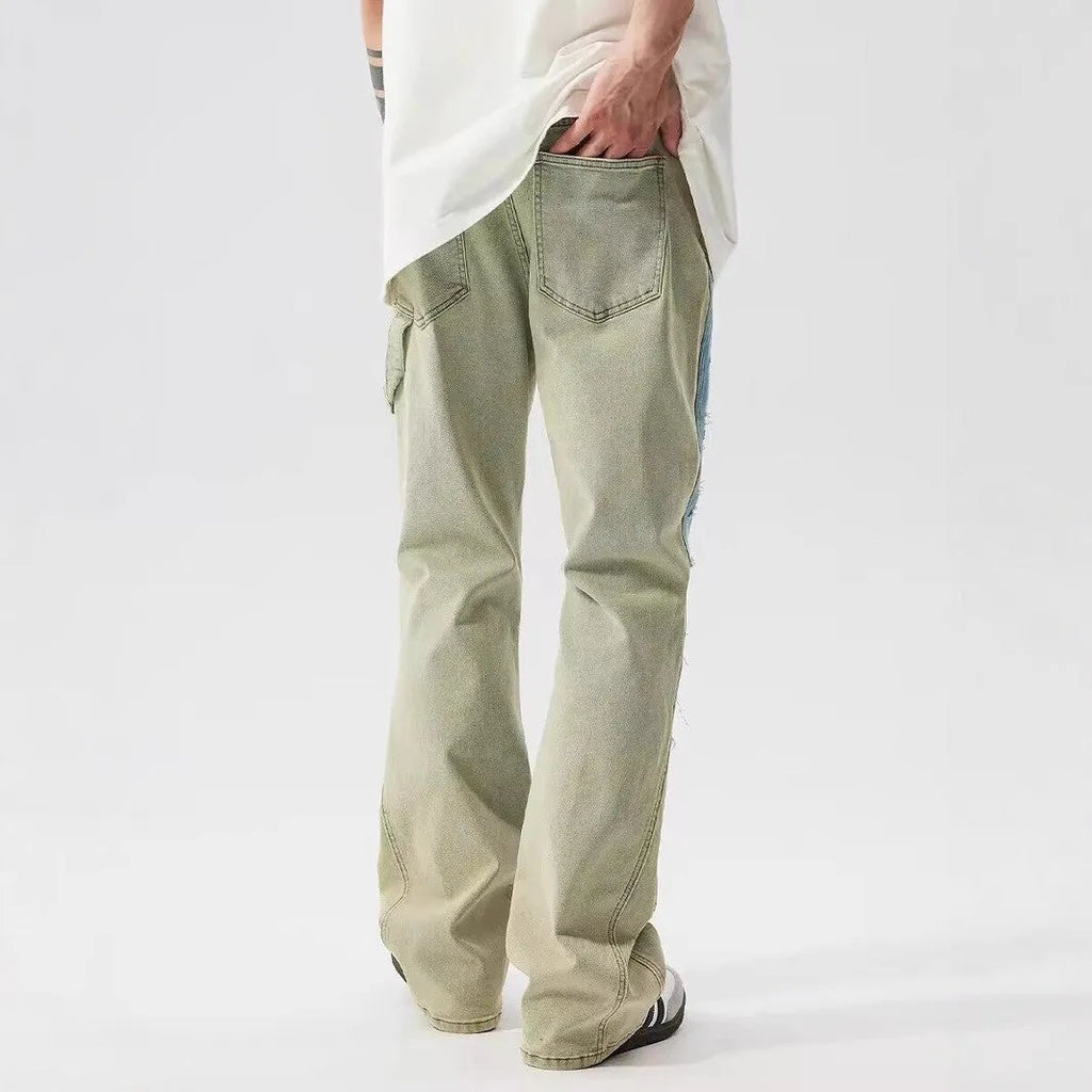 Yellow and blue retro patchwork splash-ink damaged design jeans on a mid-waist fit.