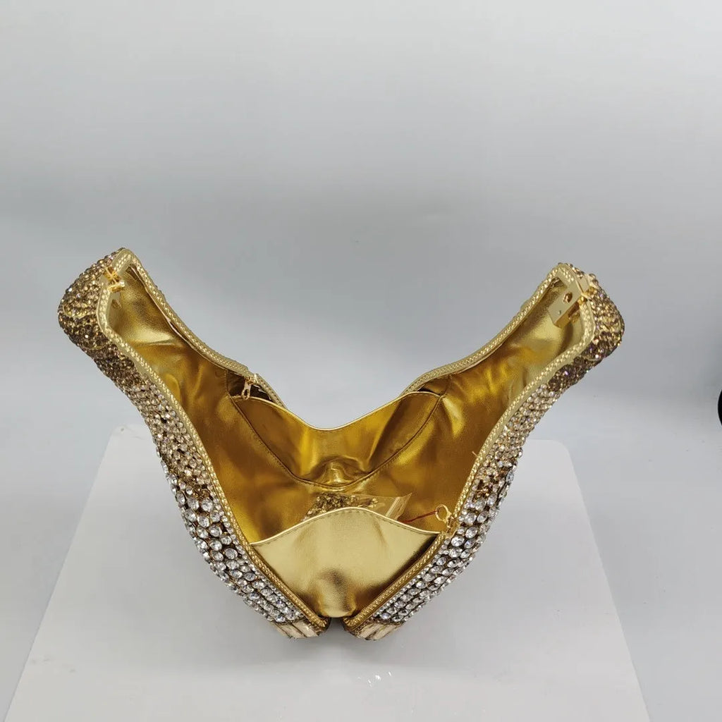 Gold champagne bottle shaped evening clutch with rhinestone decoration on black background