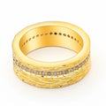 Geometric gold-coloured zircon ring for women on a plain background.