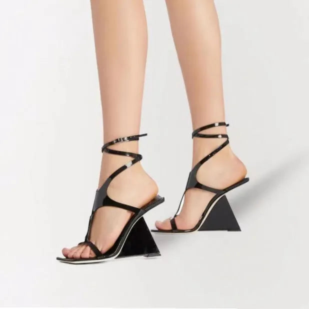 Women's black high heel sandals with 9.5cm wedge, square toe, and button fastening on a white background.