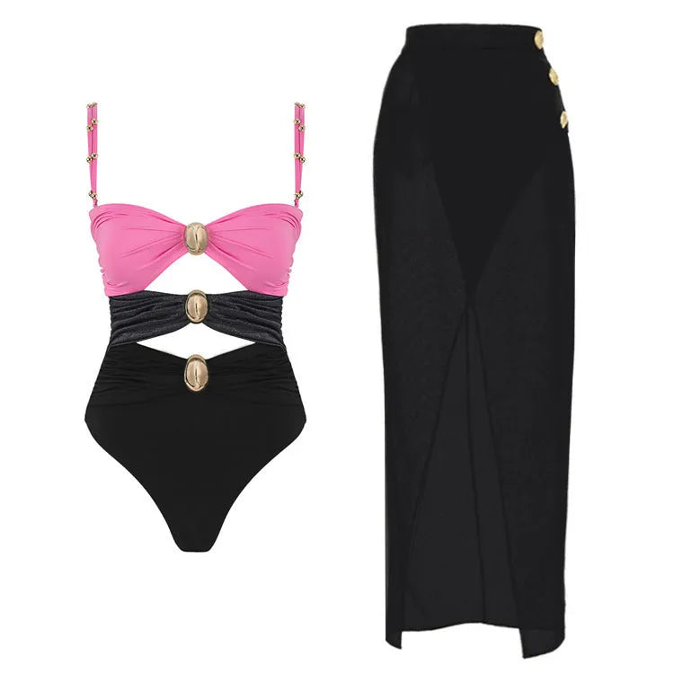 Women's black one-piece swimsuit with a removable skirt and gold button details on the front.