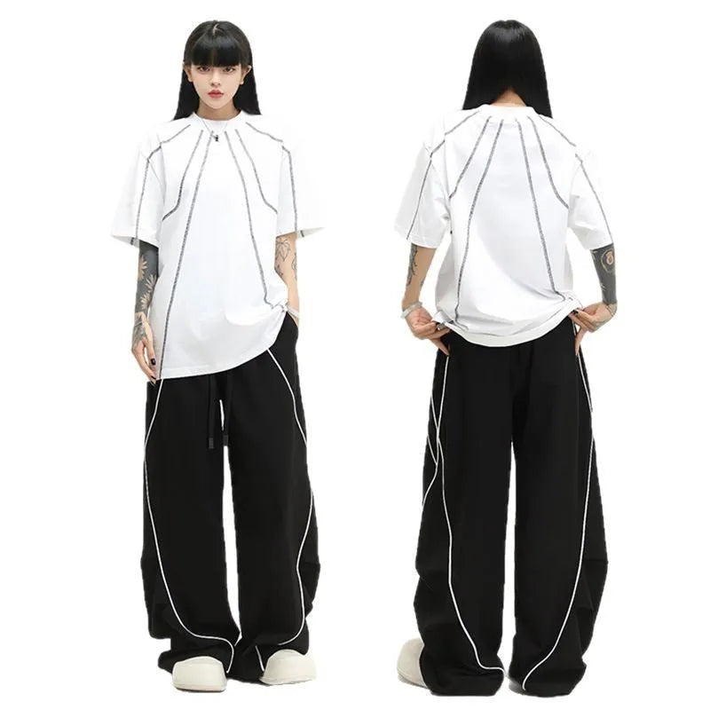 Black pleated wide-leg hip hop trousers with stripes, loose fit for sports.