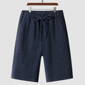 Men's beige linen loose cropped casual shorts on a neutral background.