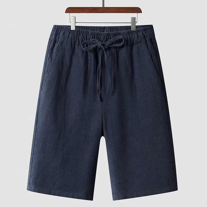 Men's beige linen loose cropped casual shorts on a neutral background.