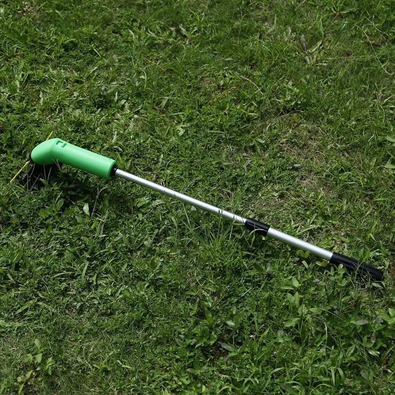 Cordless handheld grass trimmer with extension pole and protective shield on a garden lawn