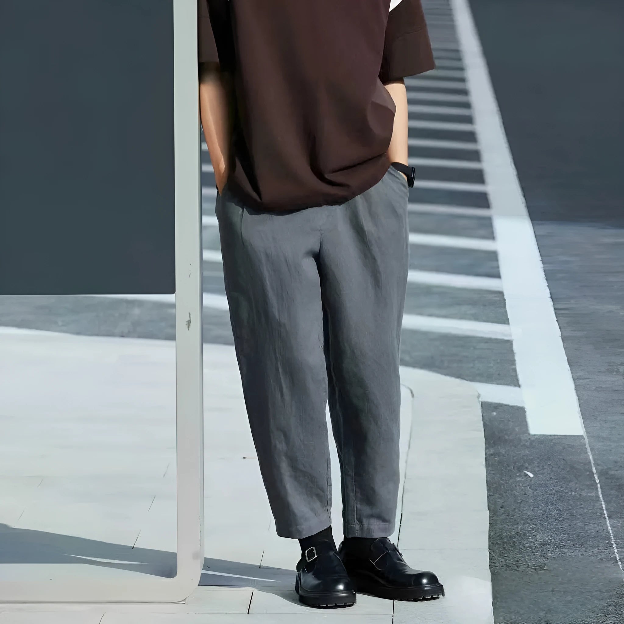 Man wearing beige loose straight casual pants with a drawstring waistband.