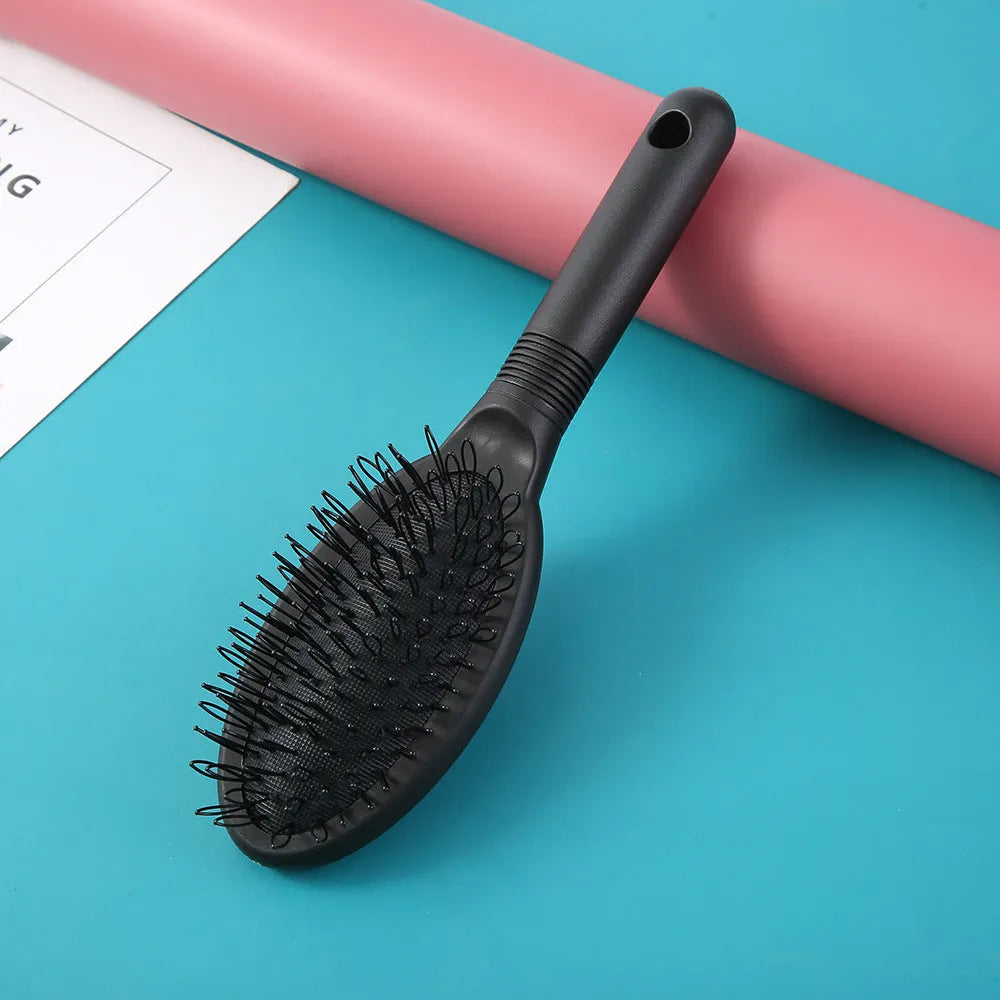 Black ABS plastic airbag comb for hair extensions measuring 22 by 6 centimetres