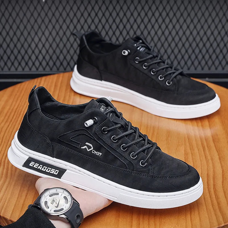 Grey men's low-top canvas casual sneakers with lace-up front and round toe on a rubber sole.