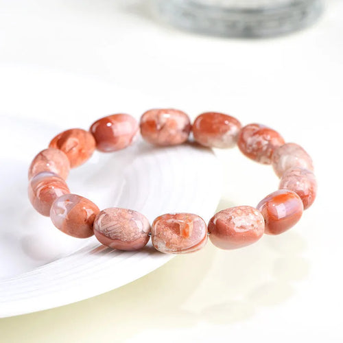 Natural cherry blossom coloured agate barrel bead bracelet with a Ruyi charm.