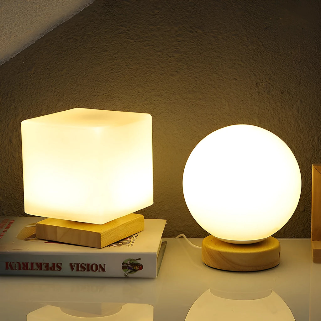 Nordic white geometric table lamp with solid wood base and USB charging port on a wooden desk.