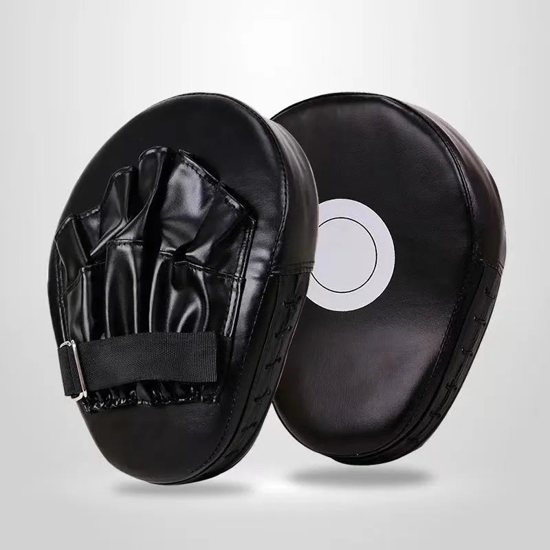 Curved red and black PU boxing punch mitts held vertically for martial arts training.