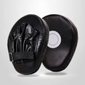 Curved red and black PU boxing punch mitts held vertically for martial arts training.