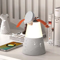 Gray 3-in-1 magnetic wireless charging Bluetooth speaker night light on a wooden table