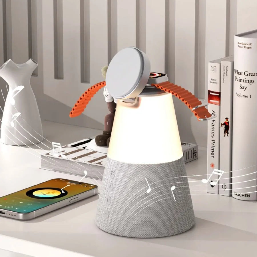 Gray 3-in-1 magnetic wireless charging Bluetooth speaker night light on a wooden table