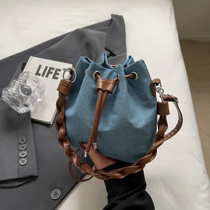 Blue one-shoulder cross body bucket bag with synthetic leather lining and medium-soft construction