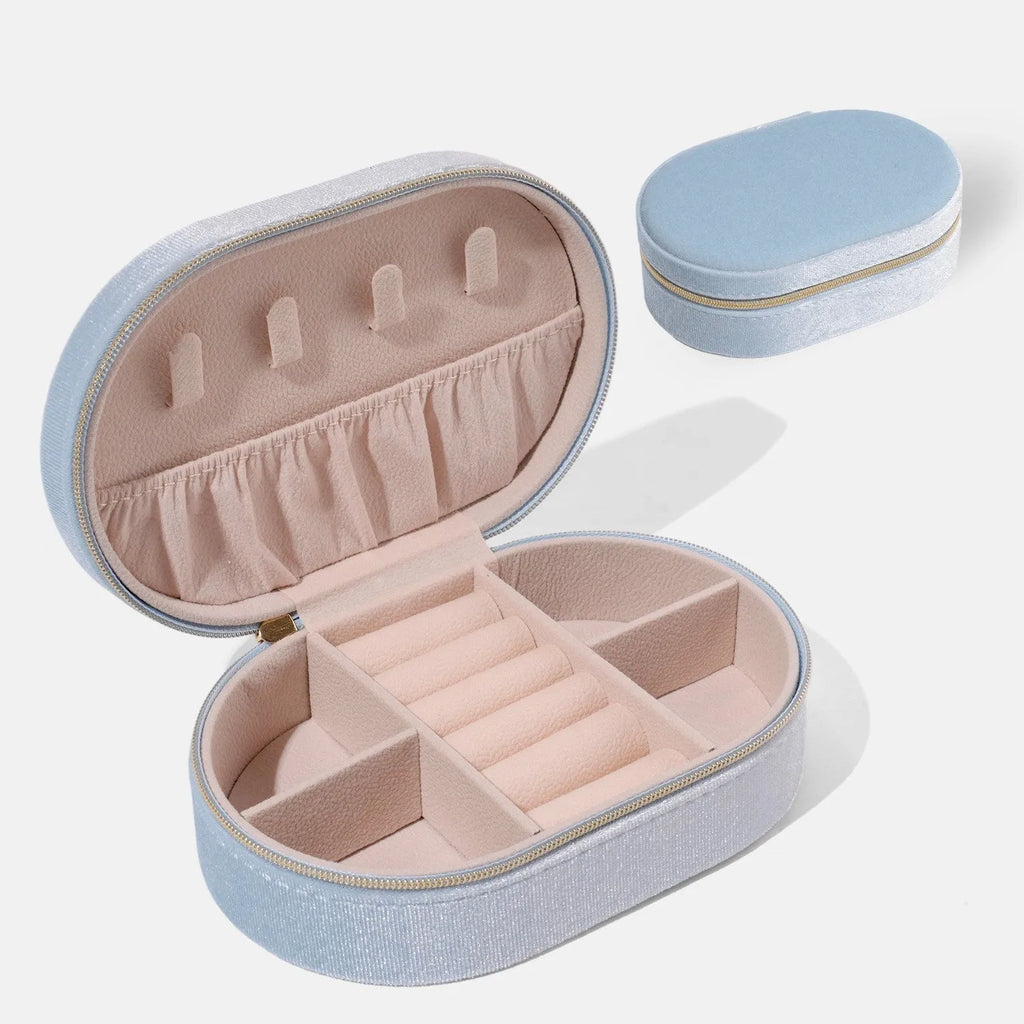 Oval velvet jewellery storage box in lake blue colour, showing soft flannel interior lining.