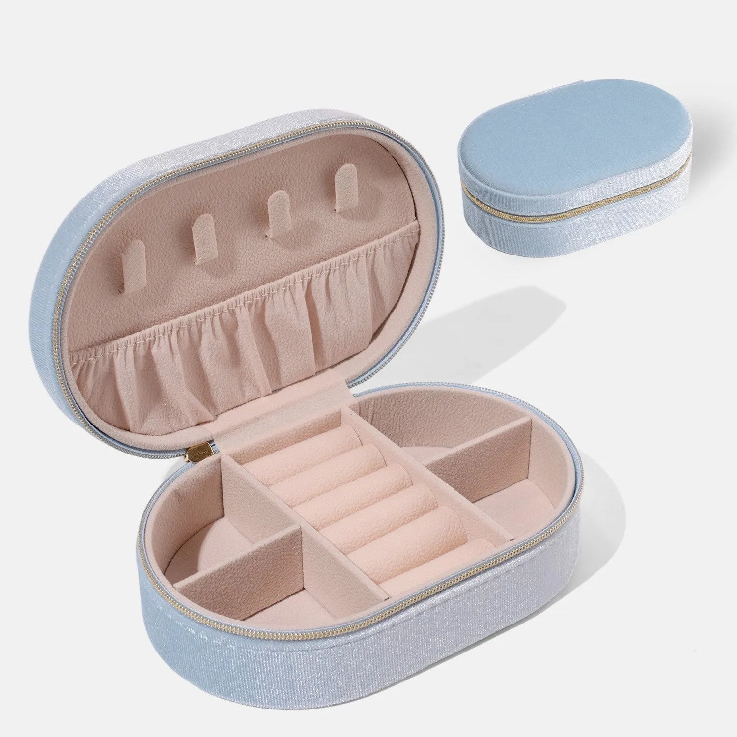 Oval velvet jewellery storage box in lake blue colour, showing soft flannel interior lining.
