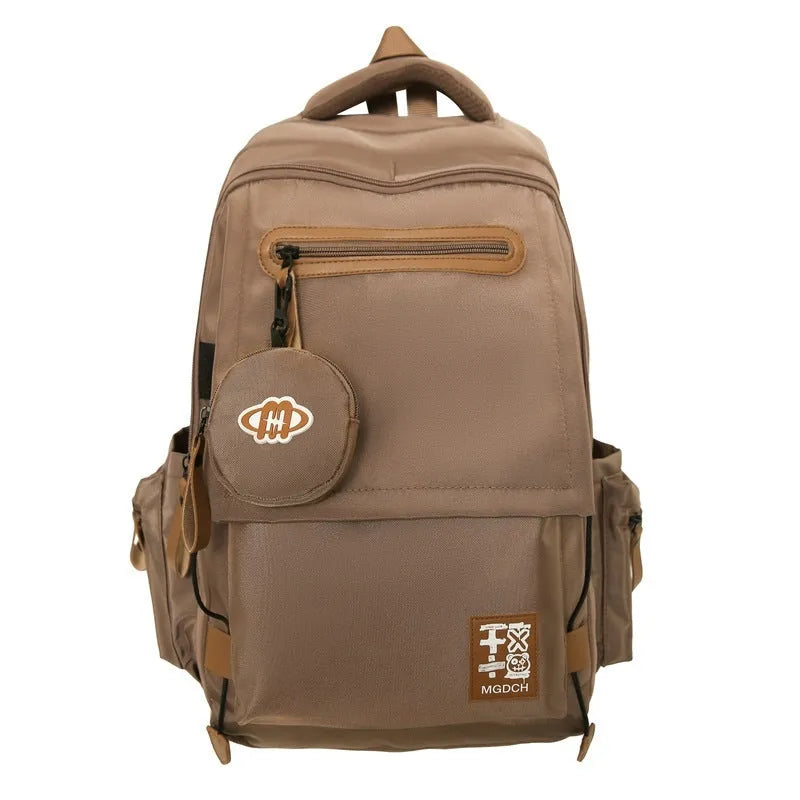 Large-capacity nylon backpack for middle school students in blue colour with curved shoulder straps.