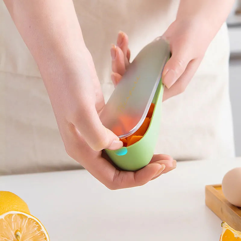 Dark green kitchen peeler with storage tube, showing stainless steel blade and non-slip handle.