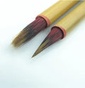 Red Chinese calligraphy brush with sheep hair and wolf tail blend on white background