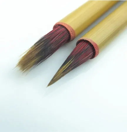 Red Chinese calligraphy brush with sheep hair and wolf tail blend on white background