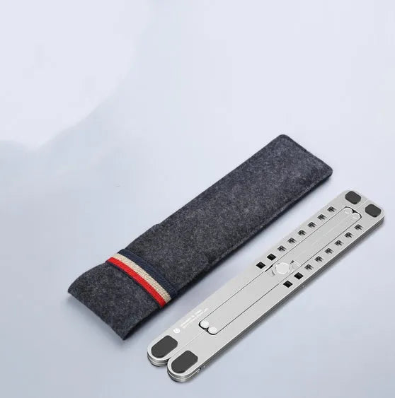 Portable aluminium laptop stand folded flat next to an open laptop showing its adjustable height.