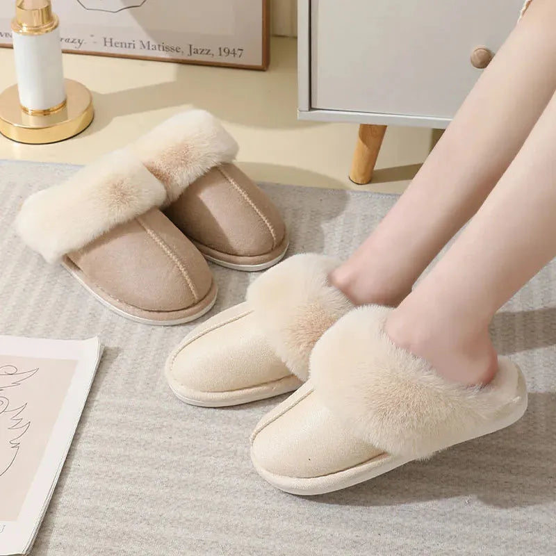 Women's plush winter slippers in grey with a round toe, flat heel, and non-slip PVC sole.