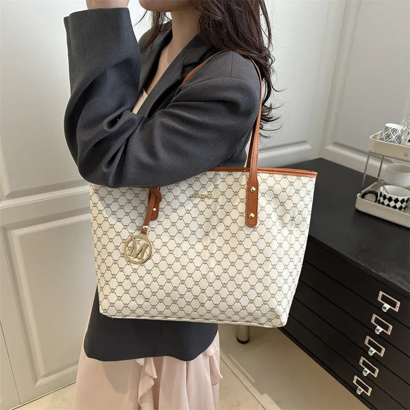 Structured PU shoulder bag in neutral colour with sewing thread detail and a long handle.