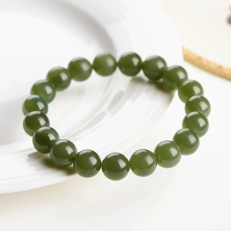 Polished Hetian jade bead bracelet in ice-like clear tones on a white background.