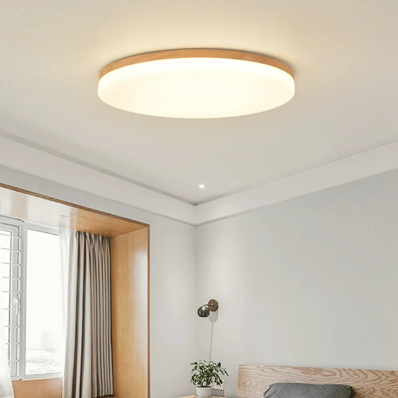 Japanese minimalist ceiling lamp with wood art body and acrylic shade in three sizes.