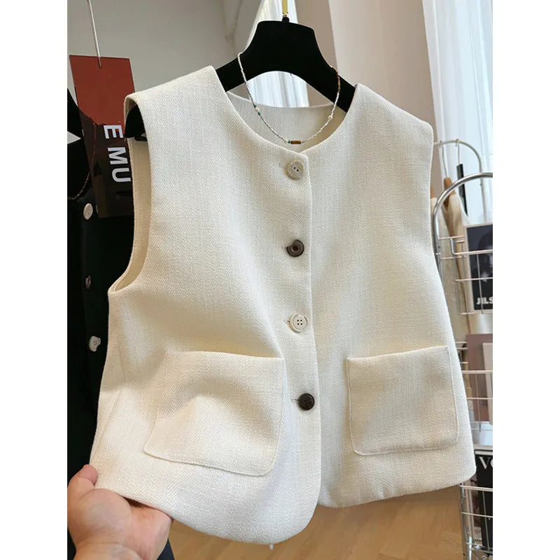 Women's milky white sleeveless bandage vest with round neck, laid flat on a surface.