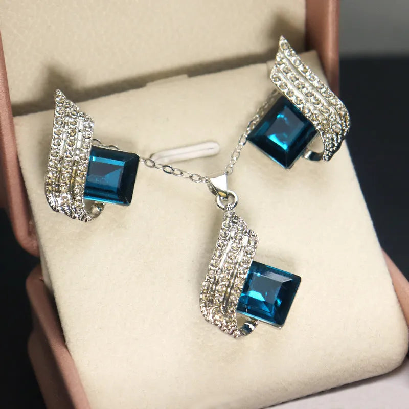 Alloy pendant necklace and matching earrings with glass ornamentation and cross chain design