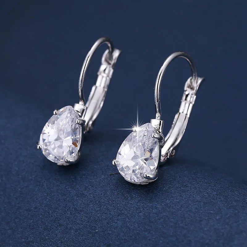 A pair of women's drop-shaped copper earrings with gemstone inlay, shown in gold and platinum colour options.