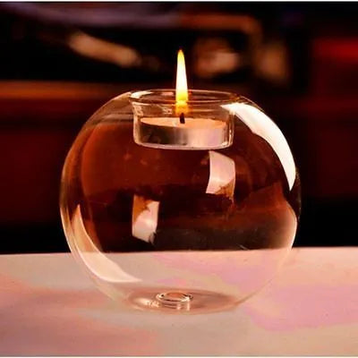Handmade round clear glass candle holder on a table