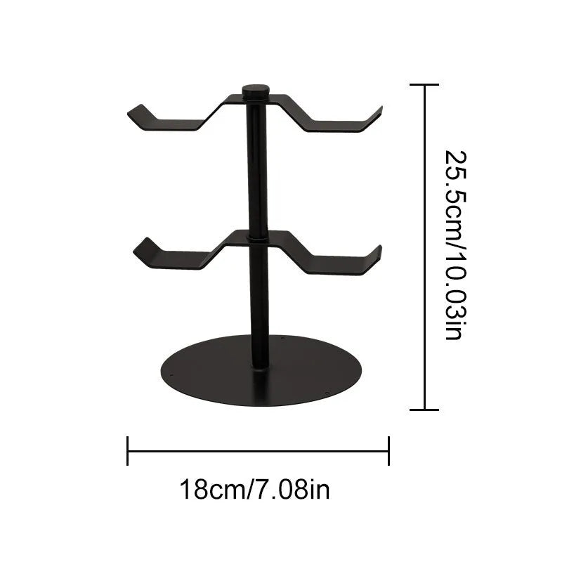Black two-layer metal headphone bracket holding gaming headsets on a desk