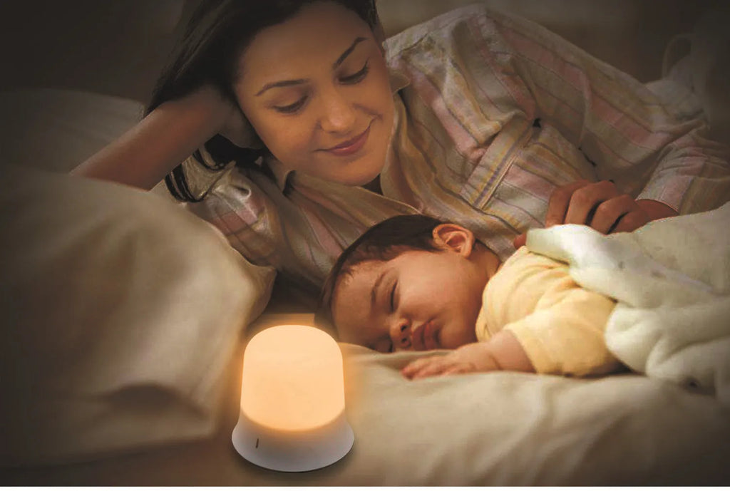 White bedside night light with touch controls for dimming and changing RGB colours on a table.