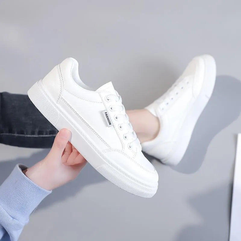 Korean style low-top sneakers in white and brown artificial PU leather with a plastic sole.