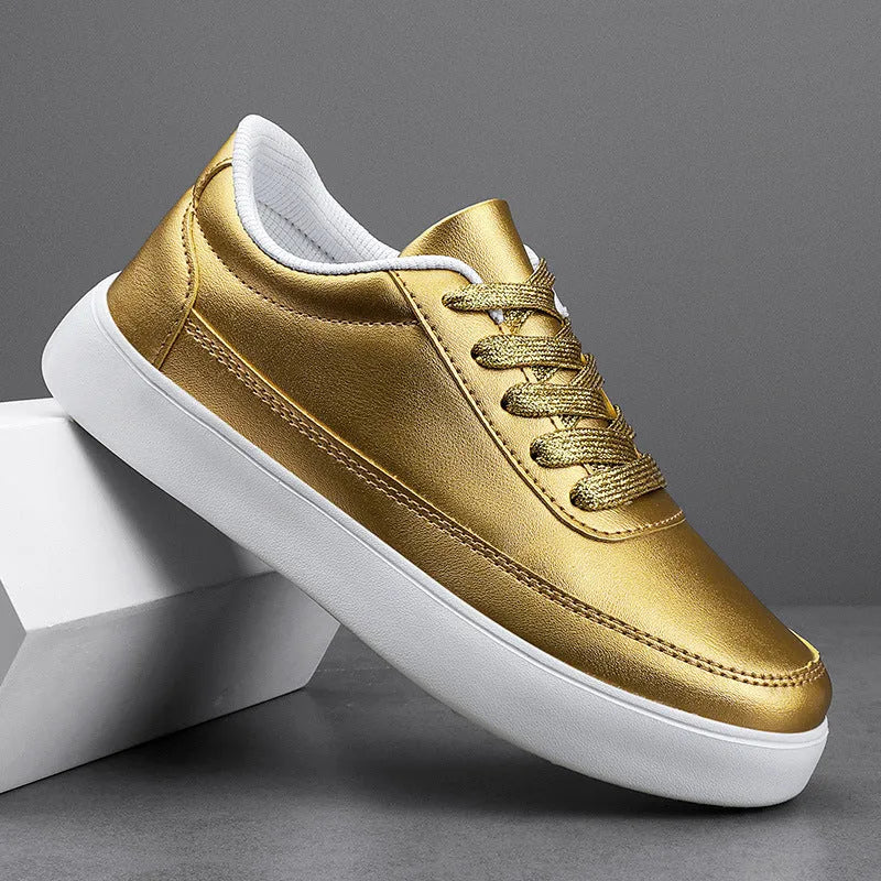 Women's gold leather flat casual lace-up shoes on a white background.